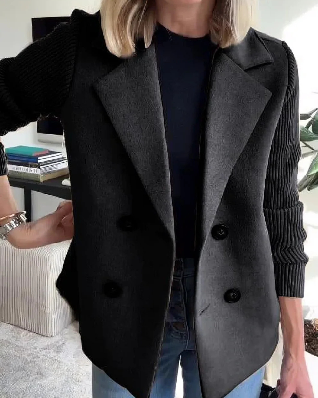 Chaqueta blazer negra con solapas, cuatro botones oscuros y mangas acanaladas
