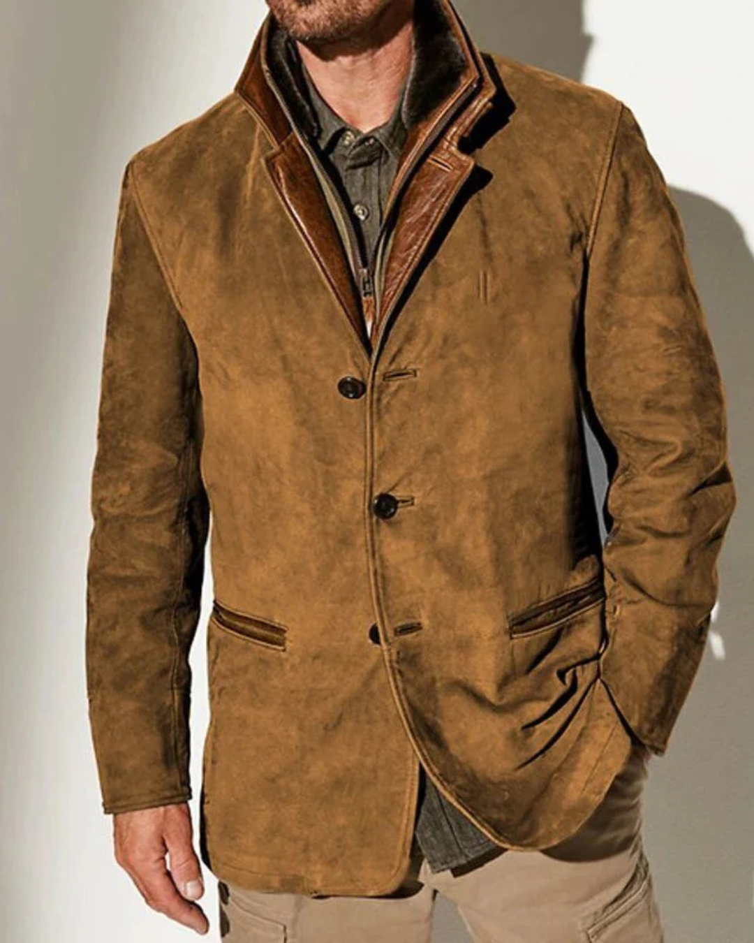 Chaqueta de ante marrón con solapa y ribete marrón, cierre de botones y bolsillos.